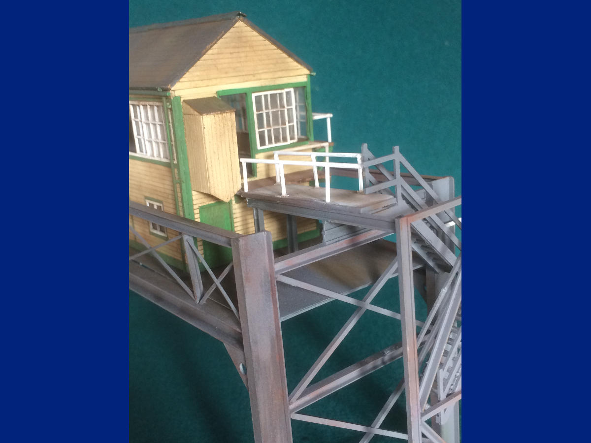 "Signal box is a one-off made for a new 4mm finescale layout, using parts, both standard and custom-cut, from LCut Creative,  with just paint, weathering, guttering & downpipes added on.  Gantry is completely scratchbuilt from plastic girders and strip,  painted and weathered accordingly.   Interior and lighting still to be added to the box"